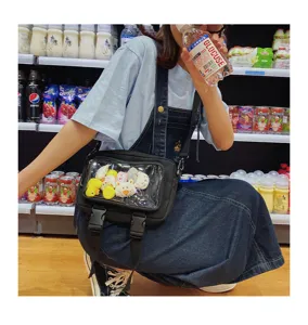 Black clear window crossbody bag with cute doll accessories, casual creative style detail display.