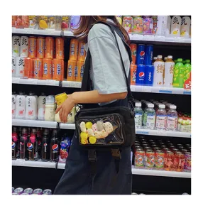 Korean style canvas crossbody bag with transparent window and cute plush toys for daily wear.