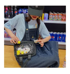 Black clear pocket crossbody bag for women, cute ita bag with cartoon plushies display.