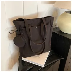 Detail view of the large capacity dark canvas tote bag with stylish coin pouch and handles.