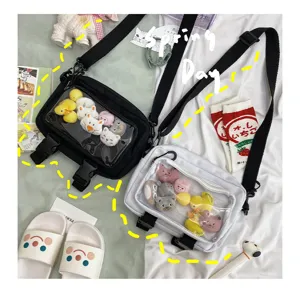 Clear window crossbody bag with cute plush toys detail view, stylish canvas bag.