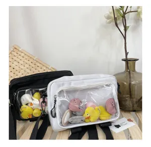 Detailed view of canvas shoulder bags with clear front pockets filled with cute plush toys.