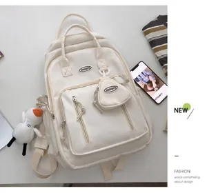 Mochila de lona lisa minimalista de estilo japonés con colgante de muñeca y bolsillo.