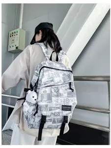 Trendy graffiti backpack for men with cute bear pendant, stylish casual school bag detail.