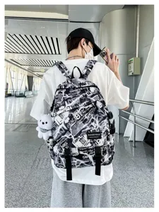 Casual black and white graffiti backpack for students, trendy school bag with bear pendant.