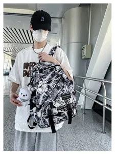 Trendy graffiti backpack for men and students, stylish black and white school book bag.