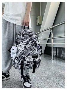 Men fashion graffiti backpack with newspaper print design, large capacity school bag for students.