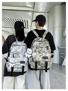 Trendy graffiti backpack for men and students, stylish casual school bag with cute bear charm.