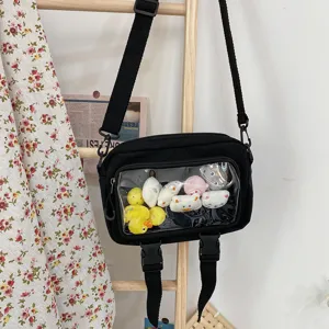 Black canvas crossbody bag with transparent window and cute plush toys display detail design.