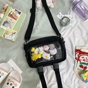 Transparent canvas crossbody bag detail shot, showing clear front window for plush toys.