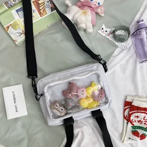 Clear canvas crossbody bag with transparent window and cute plush toys, stylish and playful daily.