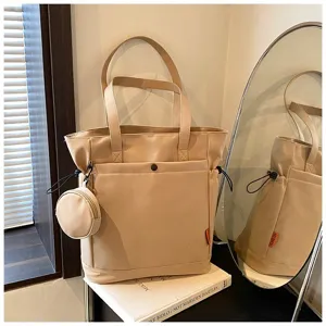 Large capacity beige tote bag with shoulder straps, front pocket and attached coin purse.