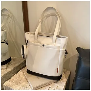 Large capacity canvas tote bag for women, stylish shoulder handbag with coin pouch.
