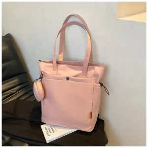 Pink large capacity tote bag with shoulder straps, front pocket and matching coin purse.