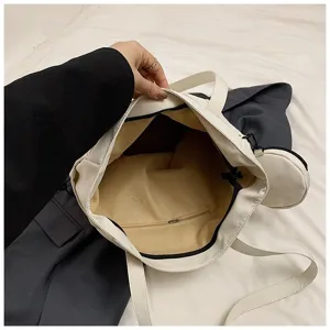 Detailed interior view of white large capacity tote bag with zipper pocket and coin pouch.