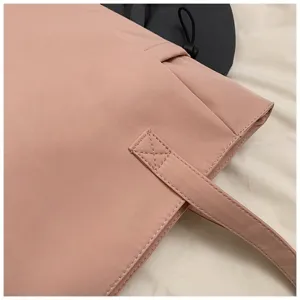 Close-up detail view of pink tote bag showing neat stitching and smooth fabric texture.