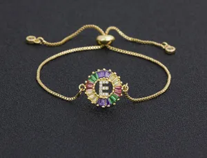 Gold-plated adjustable alphabet bracelet with colorful cubic zirconia and letter E pendant.