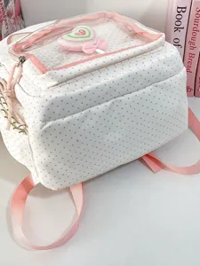 Vista dettagliata del grazioso zaino a pois rosa con una tasca frontale in PVC trasparente.