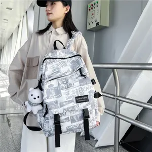 Stylish graffiti backpack for students, casual daily school bookbag with cute bear pendant.
