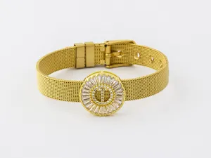 Gold plated initial T mesh strap bracelet with shimmering cubic zirconia crystal pendant details.
