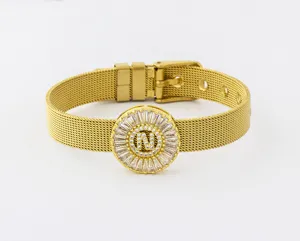 Detail view of adjustable gold mesh bracelet featuring zircon letter N pendant and buckle.