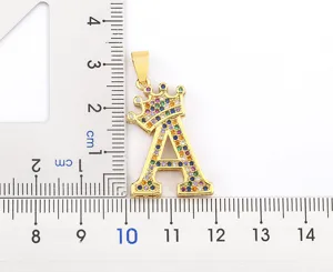 Detailed view of the gold crown letter A pendant sparkling with colorful zirconia.