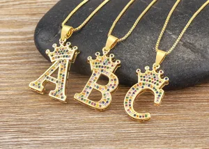 Gold plated alphabet crown pendant necklace with colorful cubic zirconia stones for women.