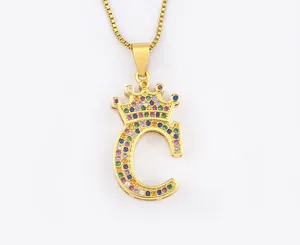 Gold-plated crown letter C pendant necklace detail shot, featuring colorful cubic zirconia stones.