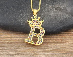 Detail shot of a gold-plated crown letter B pendant necklace with colorful zircon stones.