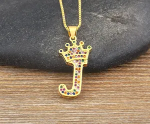 Elegant gold crown letter J pendant necklace sparkling with colorful cubic zircon stones.