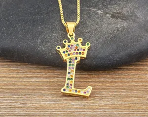 Close-up detail of a gold crown letter L pendant necklace with colorful zirconia stones.