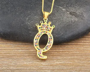 Close up view of gold plated colorful zircon letter Q crown pendant necklace details.