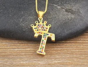Detailed close-up view of the sparkling gold crown letter T pendant with colorful zircon stones.