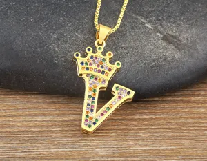 Gold crown letter V pendant necklace detail showcasing vibrant multicolor zircon stones.