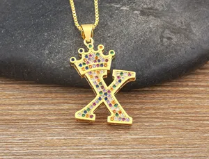 Close-up view of the gold crown letter X pendant necklace, sparkling colorful cubic zirconia.