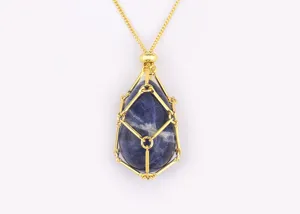 Close-up detail of a gold-plated crystal cage pendant necklace with irregular natural stone.