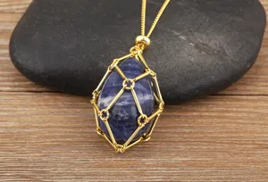 Detailed view of natural crystal stone pendant necklace with gold wire cage on wood.