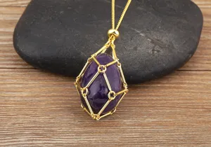 Detailed close-up of gold plated wire cage necklace holding purple amethyst crystal stone pendant.