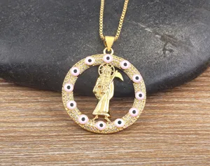 Detail view of 18k gold plated vintage scythe grim reaper pendant necklace with pink evil eyes.