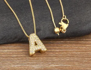 Detailed close-up of gold-plated copper micro-paved cubic zirconia letter A pendant necklace.