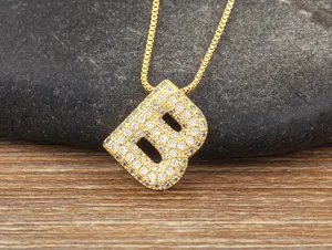 Gold-colored letter B pendant necklace featuring micro-pave cubic zirconia details on stone.