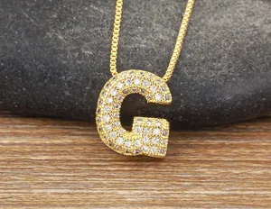 Close-up detail of gold-plated micro-paved cubic zirconia letter G pendant necklace.