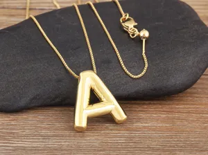 Close-up of a stylish gold 18k plated bubble letter A pendant necklace with adjustable chain.