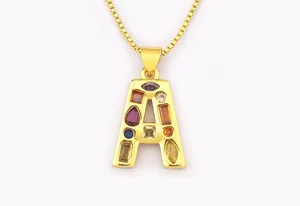 Close-up detail of the colorful zirconia letter A pendant and gold chain necklace view.