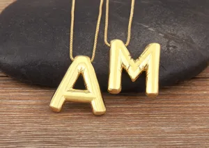 Detailed close-up view of 18k gold plated puffy alphabet letter pendants necklace.