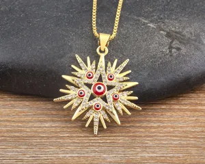Detailed view of a gold-plated star pendant necklace featuring crystal pavé and red evil eye.