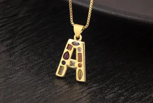 Close-up detail shot of a gold-plated letter A pendant necklace with colorful cubic zirconia.