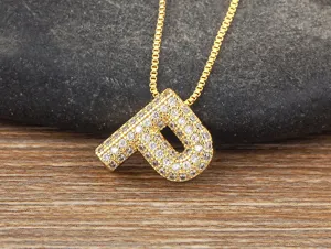Detail view of a gold letter P pendant necklace with brilliant micro pave zirconia stones.