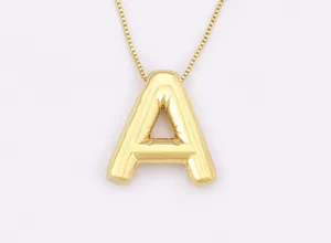 Detailed close-up shot of the shiny 18K gold plated puffy letter pendant necklace.