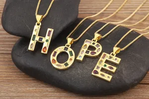 Gold-plated letter HOPE pendant necklace close-up, colorful cubic zirconia inlay details.